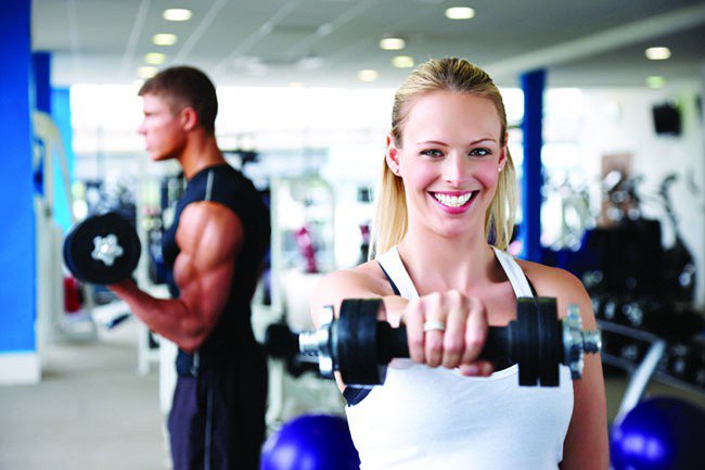 Young Adults Lifting Weights at the Gym