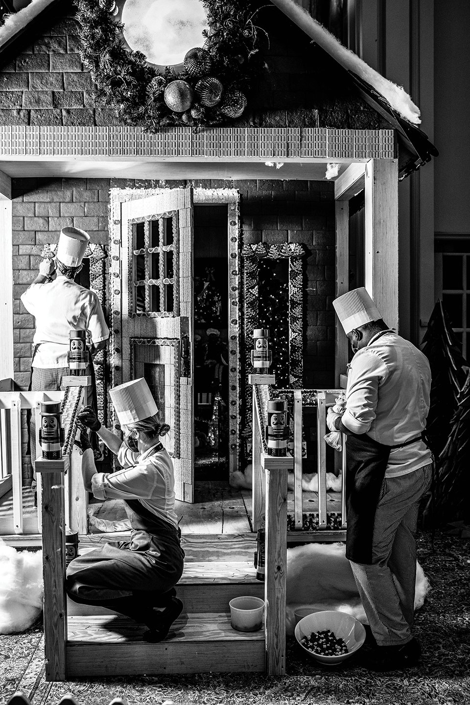 Pastry team assembling the gingerbread house