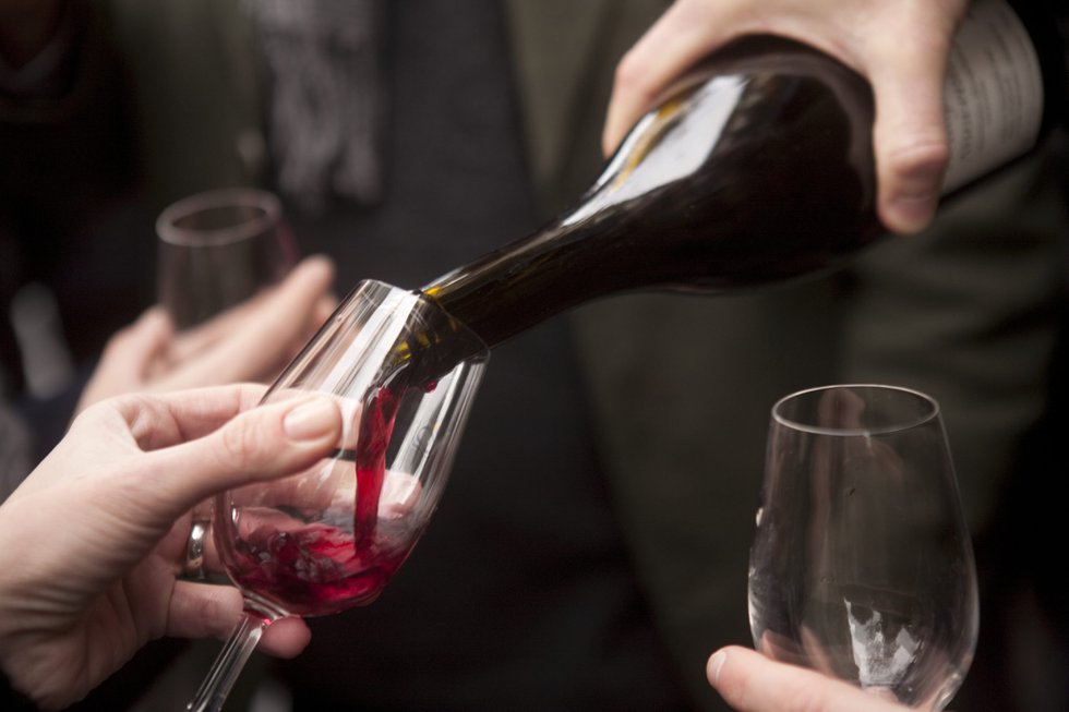 Pouring red wine at a Beaujolais nouveau festival