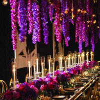 Large table setting with pink and purple flowers