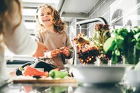 Mother and daughter washing vegetables.