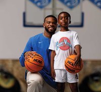 Elisha Murray and Elisha Jr. on basketball court