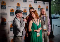 group of people on the red carpet of Artis-Naples Film Festival