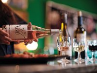 Bottle of wine being poured into a glass