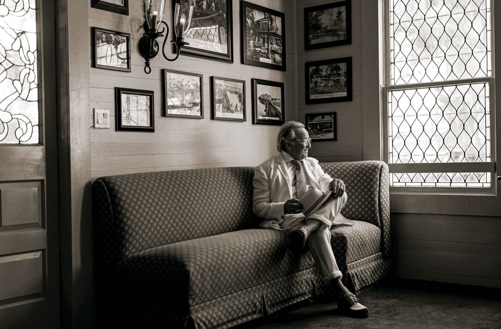 Black and white photo of Richard D’Amico sitting on bench