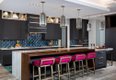 Dark, Modern Kitchen with Pink Stools.jpg