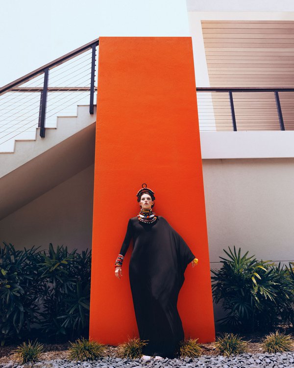 Model posing in front of orange wall.jpg