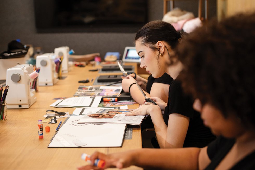 Fashion student assembling designs