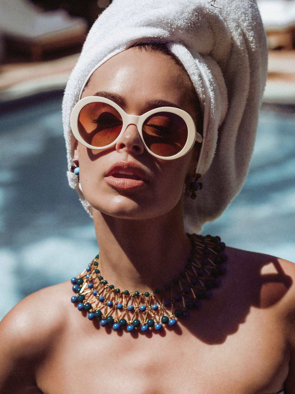 Hotel Escalante by the pool model in head towl wrap and sunglasses