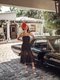 hotel escalante model wearing floral headpeice in front of vintage car