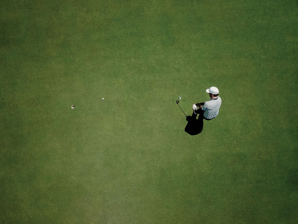 Aerial view of golfer putting