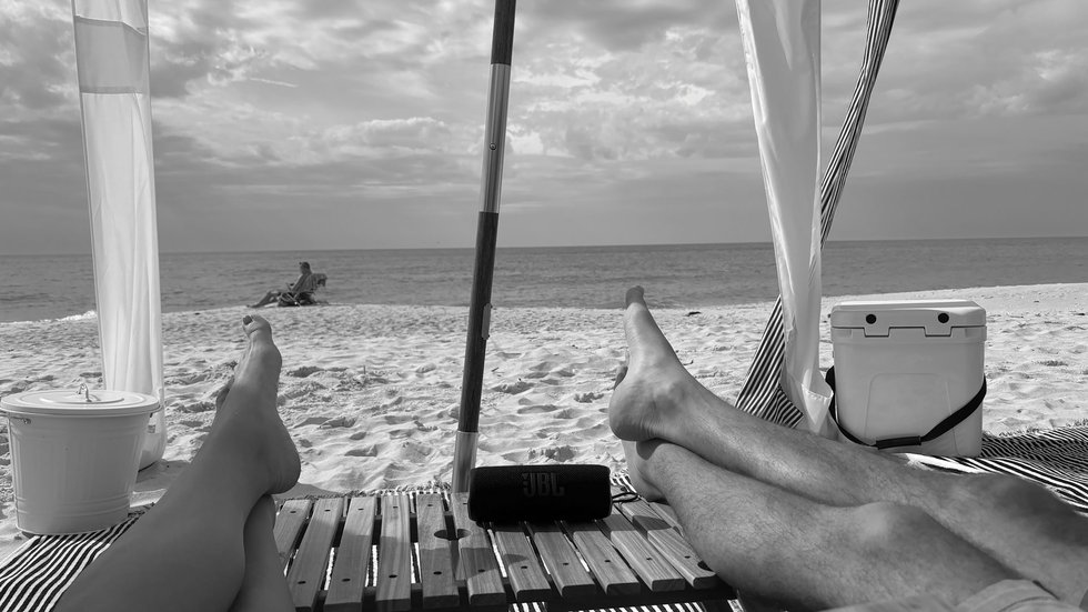 Beachgoers enjoying beach scenery under cabana