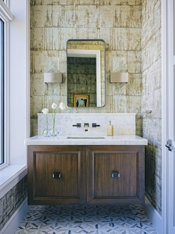 Wooden bathroom vanity with brown wallpaper and patterned tile.jpeg