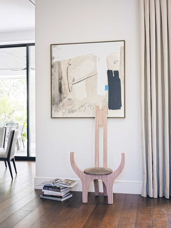 Abstract painting on wall above wooden chair.jpeg