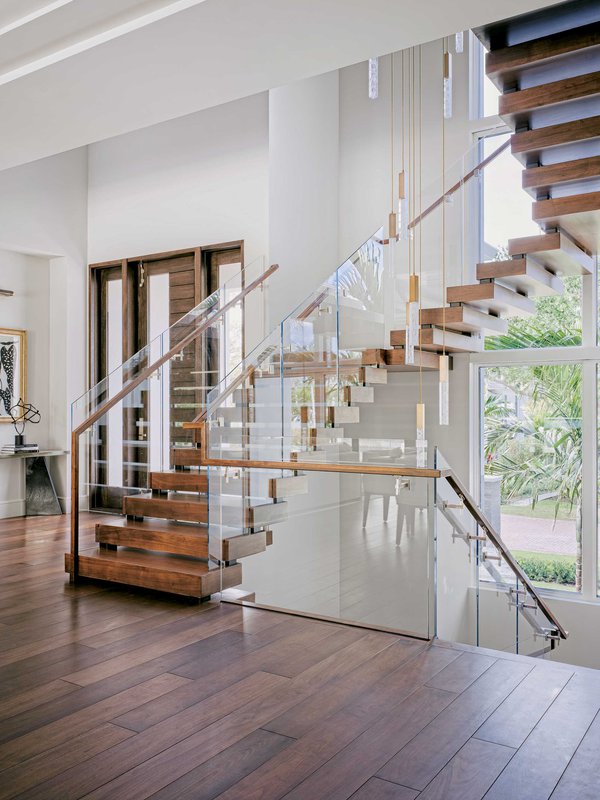 Wooden staircase with clear railing.jpeg