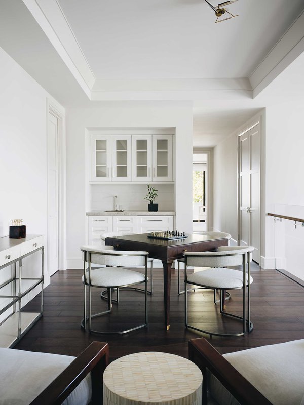 Clean white space with dark walnut wooden table and floors.jpeg