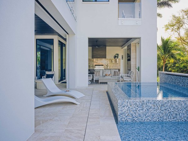 White outdoor living area with pool and spa.jpeg