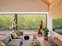 Man and woman standing in living room overlooking the canal.jpeg