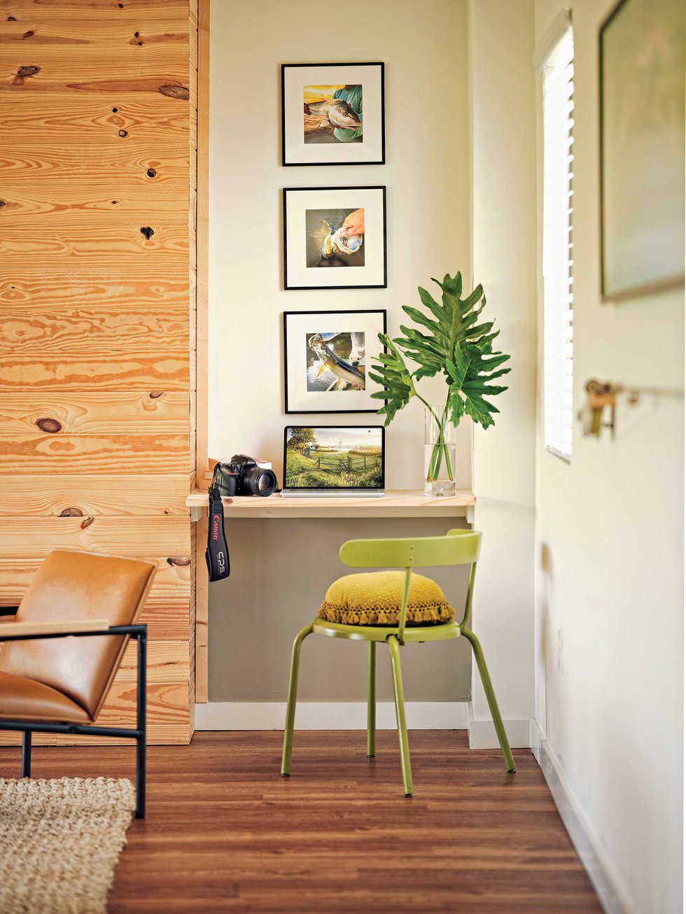 Small desk area with green chair and nature pictures.jpeg