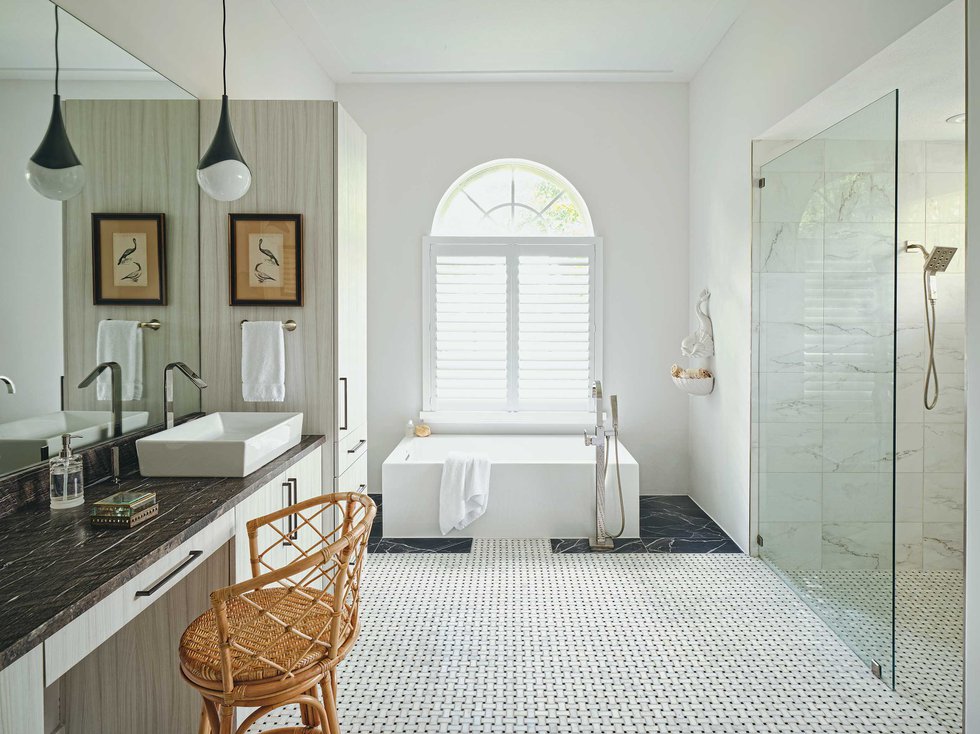 Clean white bathroom with bamboo chair.jpeg