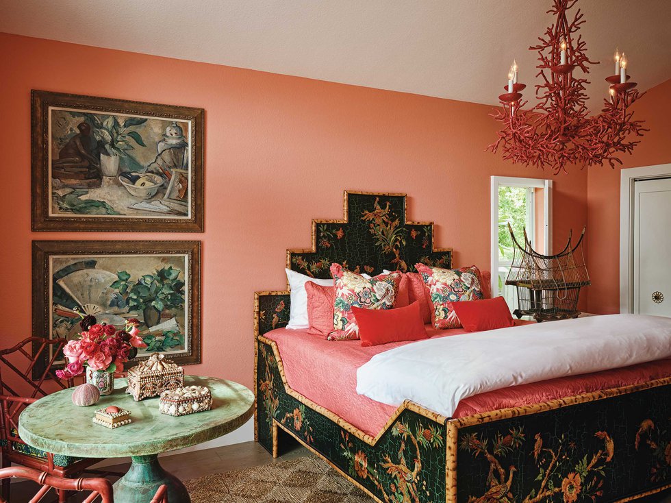 Bedroom with coral walls and bamboo bed frame.jpeg