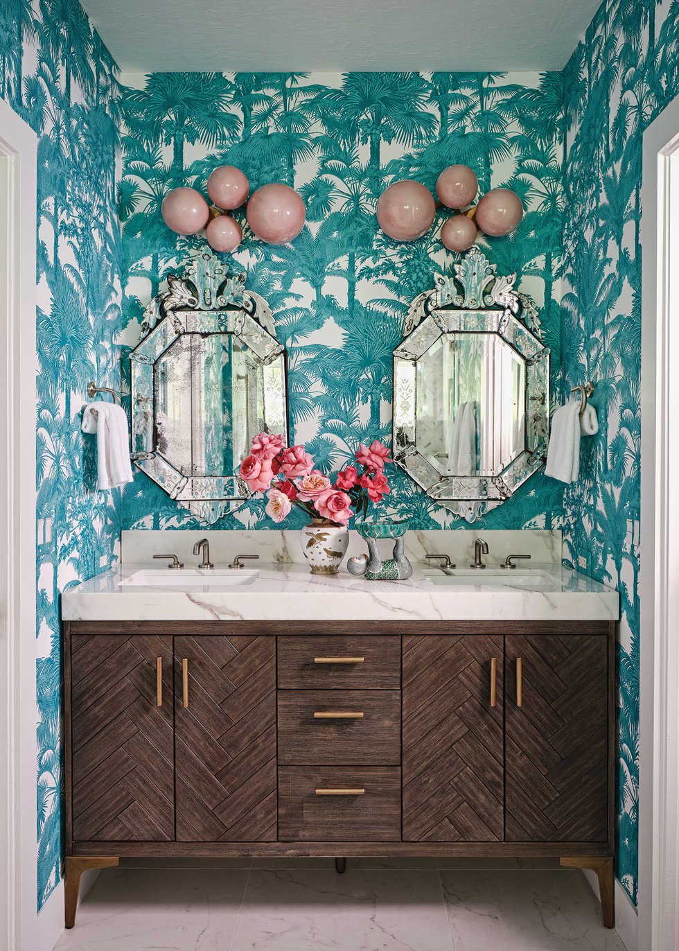 Bathroom vanity with blue and white palm tree wallpaper.jpeg