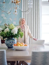 Lisa Kahn stands at her dining table