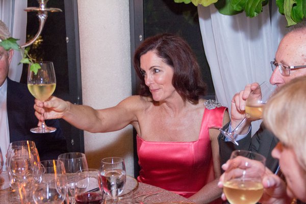 Adria starkey cheers with guests at the starkey smith dinner.jpg