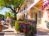 visitors walk down the road in the third street south area