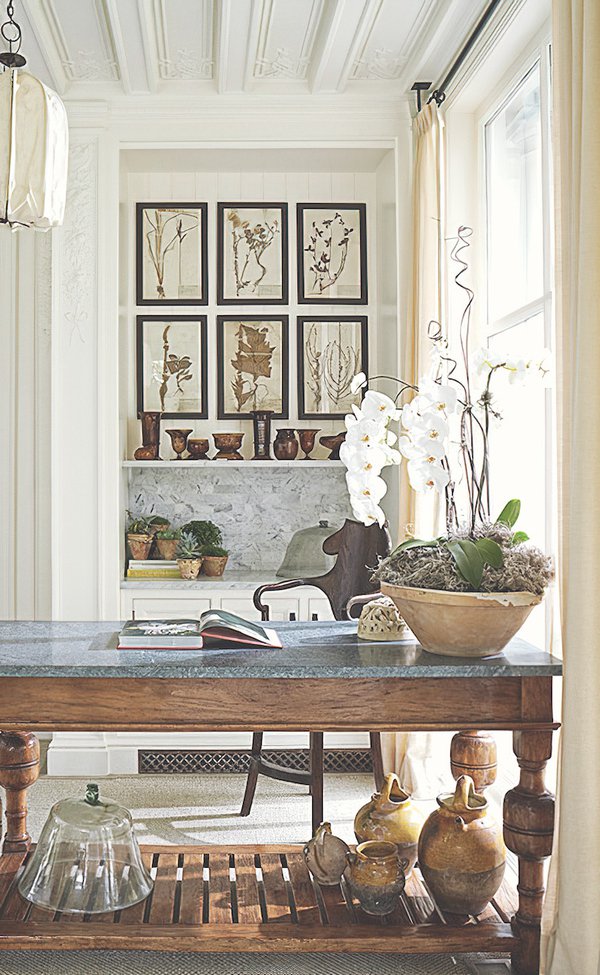 Decorated space with desk, plants, pots, books, and photos.jpg