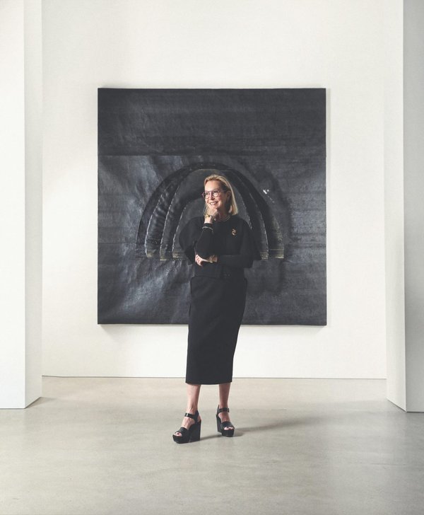 Suzanne Lovell in black dress in front of black art piece.jpg