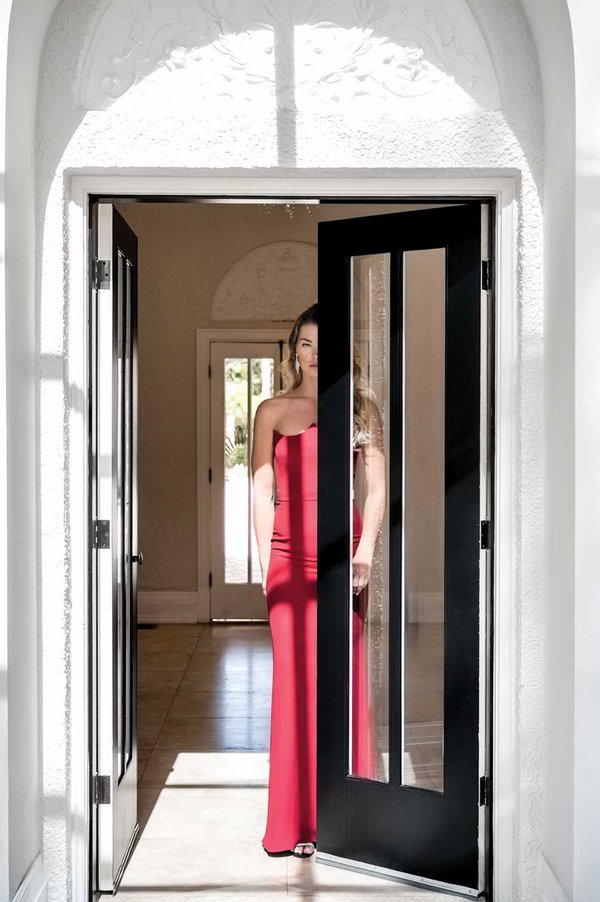 Model walking out door in red dress.jpg