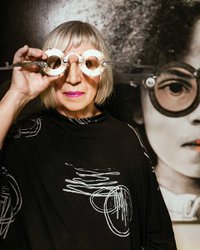 carol coates looks through artistic eye glasses